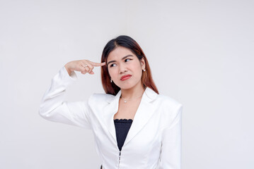 A confused young woman with finger on her temple trying to think of ideas. Isolated on a white background.