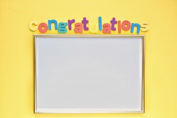 Colorful alphabet word Congratulations and frame on yellow background. Graduation concept. Primary...