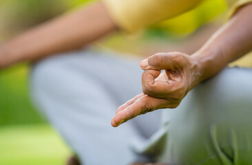 Close up shot of indian senior woman doing meditation with yoga mudra at park - concept of...