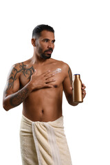 man applies moisturizing cream to his skin, holding a brown colored package, male skin care