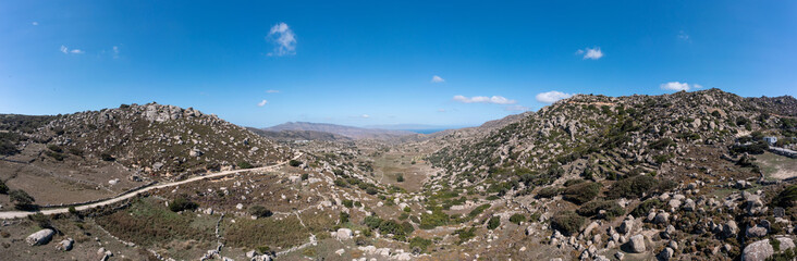 Fototapeta na wymiar Panoramic view of huge rock, plateau, valley, Volax Tinos island Cyclades Greece. Banner