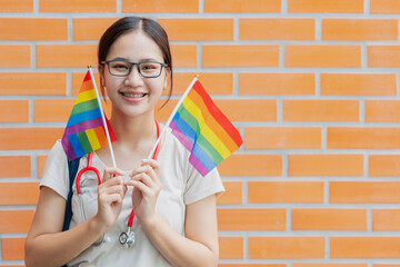 Happy medical people woman teen girl with LGBT rainbow pride month flag diversity campaign activity.