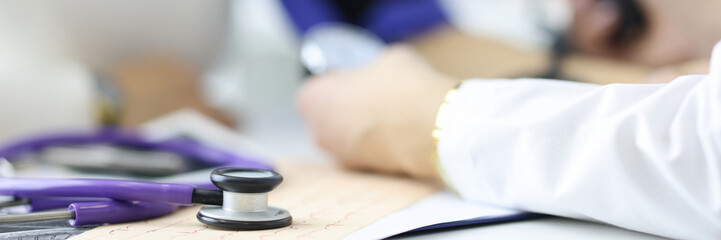 Cardiologist measures blood pressure in cardiology department of hospital. Electrocardiogram and control of pressure and heartbeat