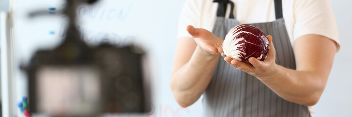 Chef blogger broadcasts on camera and talks about healthy eating. Vegetarian food and healthy nutrition video blog concept