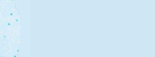 Smeared transparent gel with blue granules. On a blue background.