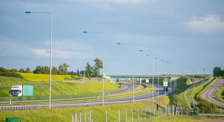 Gdansk, Poland - May 26, 2022: Cars on the highway. Expressway in the rays of the setting sun....