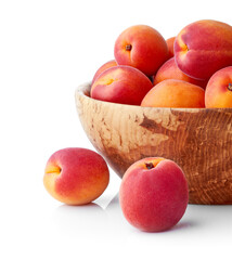 Fresh apricots in the wooden bowl still life of ripe fruits. Apricot Fruits isolated on white background. Vegan organic healthy food stillife