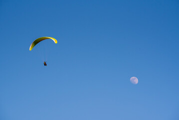 Player flying towards the moon with blue sky