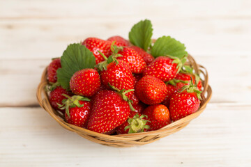Fresh strawberries in bowl on wooden table