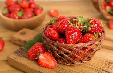 Fresh strawberries in bowl on wooden table