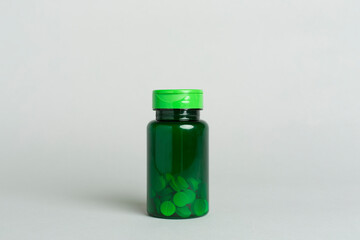Plastic bottle for vitamins on color background