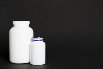 Plastic bottles for vitamins on color background