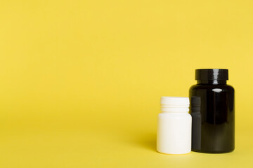 Plastic bottles for vitamins on color background