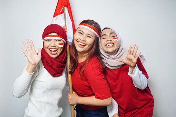 happiness of a group of young people using the red and white attributes to commemorate independence...