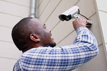 African American Handyman With CCTV Camera