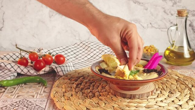 dipping pita bread in hummus - 4K 60 High quality colors