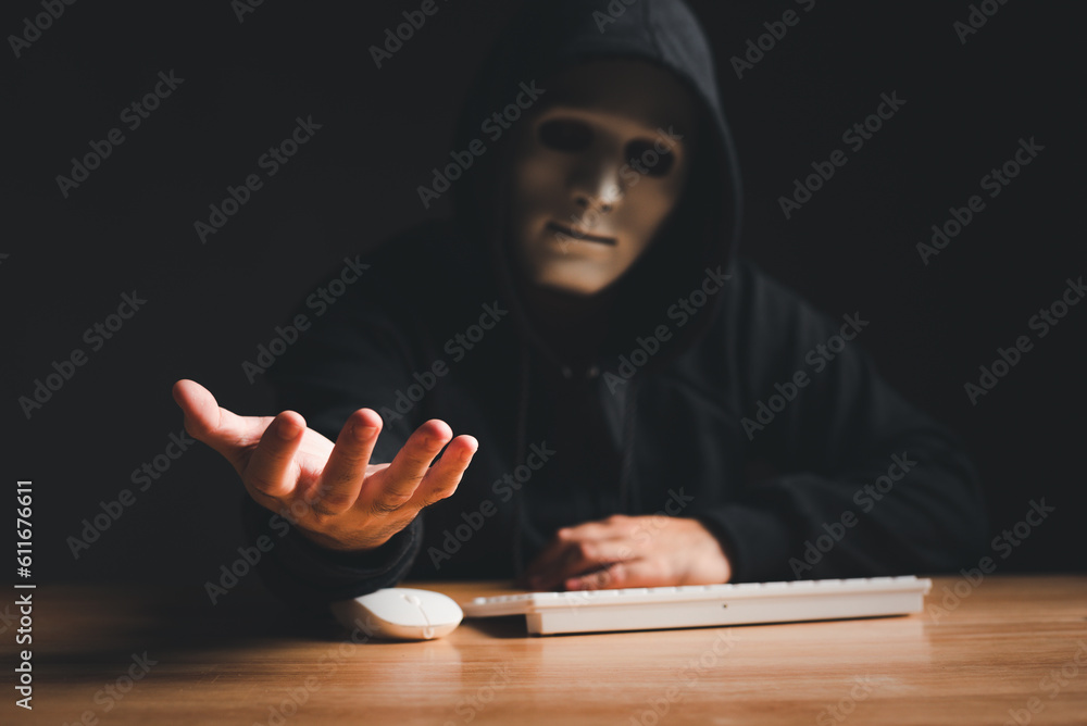 Poster black hat hacker force demands ransom by holding out his hand on table where sensitive data is hacke