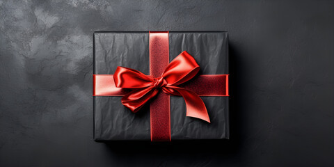 Black box with red bow on white background top view. gift box.