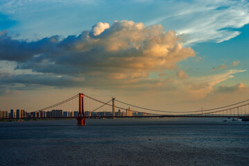 Fototapeta na wymiar Yangtze river and bridge under white clouds and blue sky, Wuhan, China, urban landscape