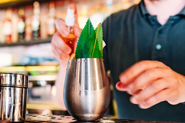 man hand bartender making cocktail in glass on the bar counter