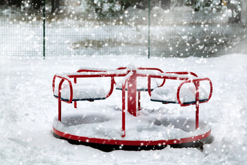Urban scene of city life in winter in a snow storm. Winter on the playground. Playground in the park under the snow.