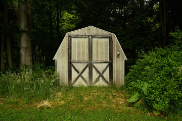 Rustic barn shed set in woods background