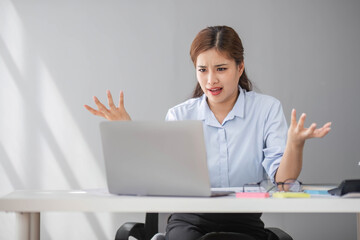 Puzzled confused asian woman thinking hard concerned about online problem solution looking at laptop screen, worried serious asian businesswoman focused on solving difficult work computer task