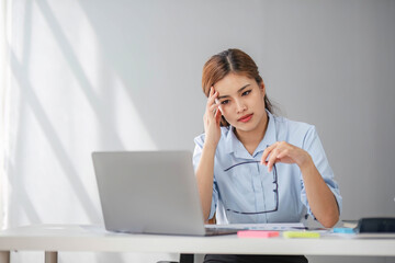 Puzzled confused asian woman thinking hard concerned about online problem solution looking at...