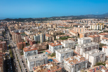 Aerial drone photo of the beautiful beach front of the coastal town of Fuengirola in Malaga Spain Costa Del Sol, showing the sandy beach, hotels and apartments with the mountains in the background