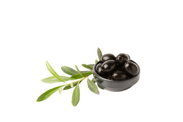 Black olives isolated on white background. Olives in a bowl. Olive tree leaves. Vegan. Ingredient for salad or pizza.