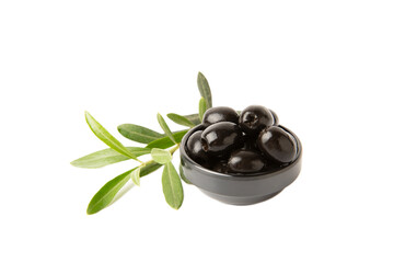 Black olives isolated on white background. Olives in a bowl. Olive tree leaves. Vegan. Ingredient for salad or pizza.