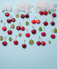 Cloud with charry and leaves as rain. Minimal summer concept background. Copy space