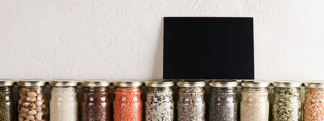Zero waste lifestyle concept. Responsible consumption, healthy vegetarian food. black board for text on glass with food containing proteins. banner