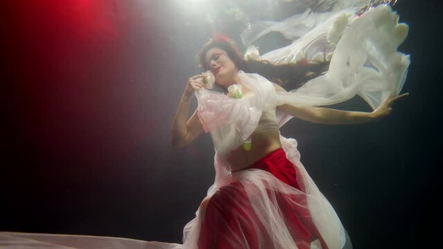 fantasy and fairytale, underwater shot with beautiful woman figure in deepness, princess of sea