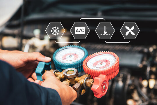 Car care maintenance and service, Hand technician auto mechanic using measuring manifold gauge check refrigerant and filling car air conditioner to fix repairing heat conditioning system.
