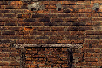 Fototapeta na wymiar Orange old brick background on house wall. The old brick floor is evenly arranged with dry moss clinging to the surface. Old, symmetrical background image icons.