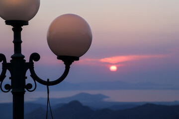 View of Sunset with Mountains and a Lantern in Naxos, Greece