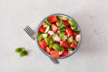 watermelon salad with feta cheese, cucumber and basil. healthy summer dessert