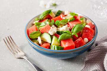 watermelon salad with feta cheese, cucumber and basil. healthy summer dessert