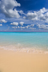 Obraz premium Sunny closeup of sea sand beach blue summer sky. Panoramic beach landscape. Tranquil relaxing sunshine soft waves splashing on Mediterranean sandy shore. Coastline seaside idyllic nature background