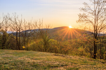 Sunrise with sunburst over mountain in Blue Ridge during early spring