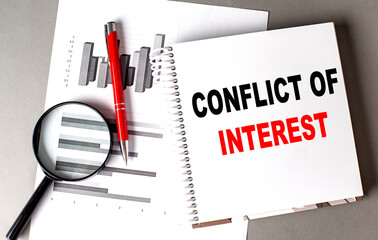 CONFLICT OF INTEREST text written on notebook with chart
