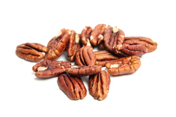 Heap of pecan nut halves isolated on a white . Peeled pecan nuts closeup
