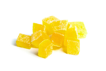 Dehydrated mango dices isolated on white. Dried mango cubes. Heap of candied diced fruits closeup
