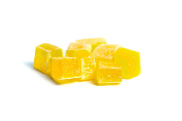 Dried mango cubes isolated on white. Diced mango closeup. Heap of sweetened fruits