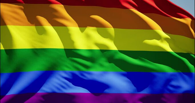 Rainbow LGBT pride flag waving in wind. Realistic Gay fabric background. International Day Against Homophobia. Background with rainbow colors