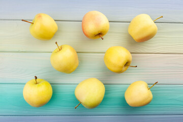 yellow apples on wood background