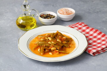 Homemade stewed green beans, tomatoes, garlic with olive oil. Zeytinyagli fasulye traditional food. Turkish cuisine. Haricot. 