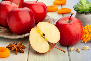 sliced red apples on wood background