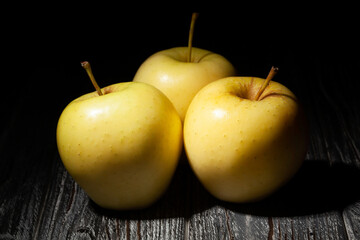 yellow apples on wood background